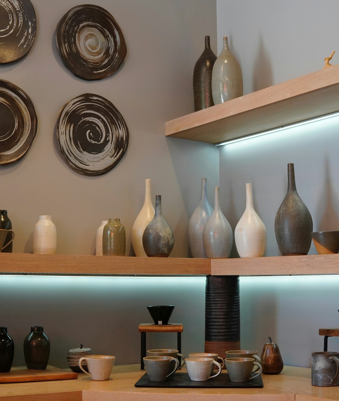 Vases and plates on the lit front shelves