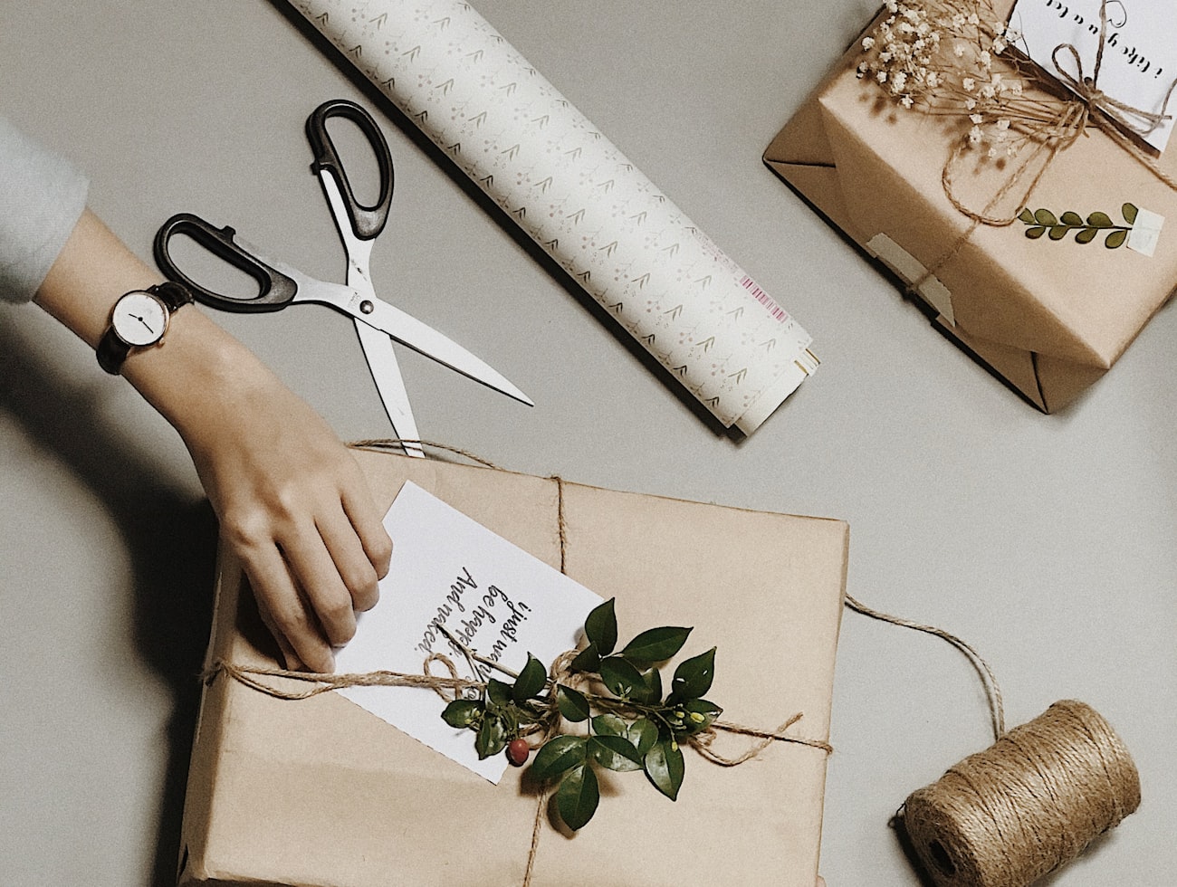 Brown paper, string and scissors on the wrapping bench